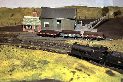 A Br Class4F freight loco approaches the station.