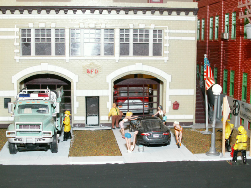 Girls washing a car for charity fundraiser to support the local fire department