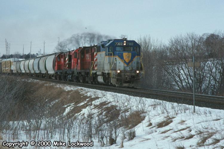 DH 7303, CP 1861, 4243, and 1850 at Wesleyville, ON., on #906, Feb.5, 1998