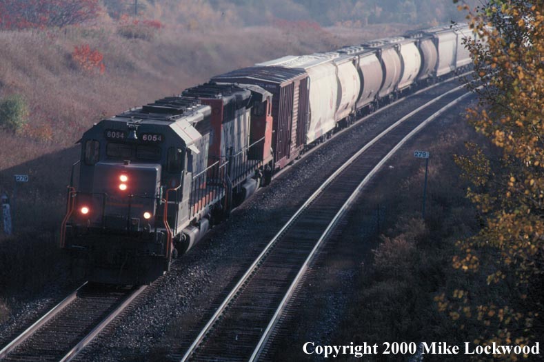 GCFX 6054 & unidentified CN SD40-2W on #309-19 Newtonville Oct.20, 2000 0935