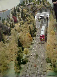 This photo is an overview of WNYSSA's Lew Cabello's trestle and tunnel modules as an American Flyer model 362 Santa Fe locomotive crosses the trestle.
