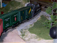 A New York Central road switcher has picked up its consist and is heading for the main line.