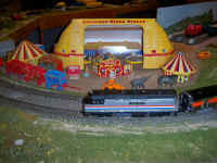 The passengers on this Amtrak train get a peek at the American Flyer Circus they go by.