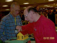 Don Confarotta discusses the log loader with Dave Blaufuss of Dave's S Gauge Trains.