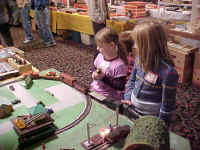 These young ladies are getting a close-up view of the action cars on the layout.