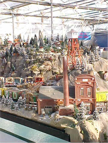 A closeup of the fire tower and power plant on  the Garden Factory train display