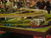 A Union Pacific coal and Amtrak trains meet on the great bend of the Flower City Tinplate Trackers  modular layout.