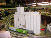 A large grain elevator on a corner of the Flower City Tinplate Trackers club modular layout